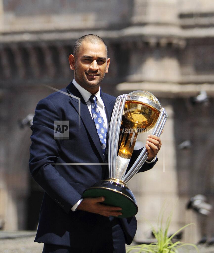 Gurinder Osan FILE - In this Sunday, April 3, 2011, file photo, Indian cricket captain Mahendra Singh Dhoni poses with the World Cup trophy in front of the Gateway of India monument, in Mumbai, India. India great Dhoni announced his retirement from international cricket on Saturday, Aug. 15, 2020. Under Dhoni’s stewardship, India won the T20 World Cup in 2007, the 50-over World Cup in 2011 and the Champions Trophy in 2013. (AP Photo/Gurinder Osan, File)