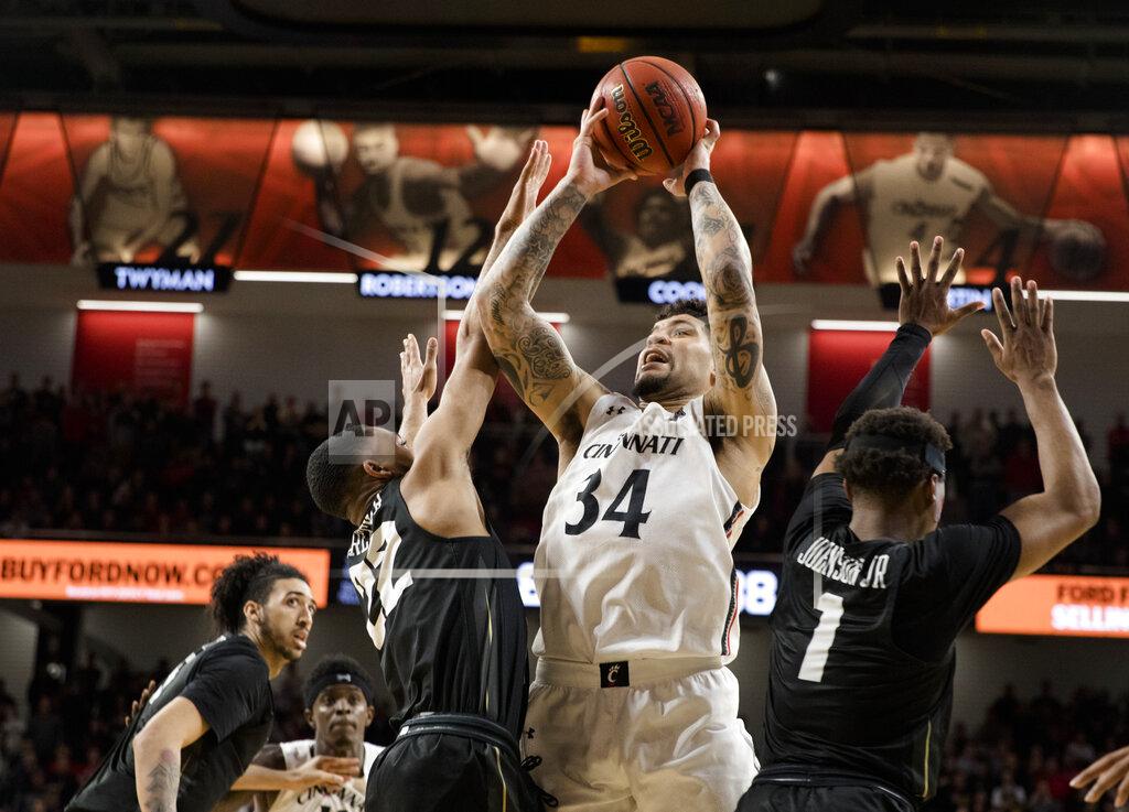 Albert Cesare Cincinnati guard Jarron Cumberland (34) misses a shot as he shoots over Central Florida guard Darin Green Jr. (22) and guard Tony Johnson Jr. (1) in overtime of an NCAA college basketball game Wednesday, Feb. 19, 2020, in Cincinnati. (Albert Cesare/The Cincinnati Enquirer via AP)