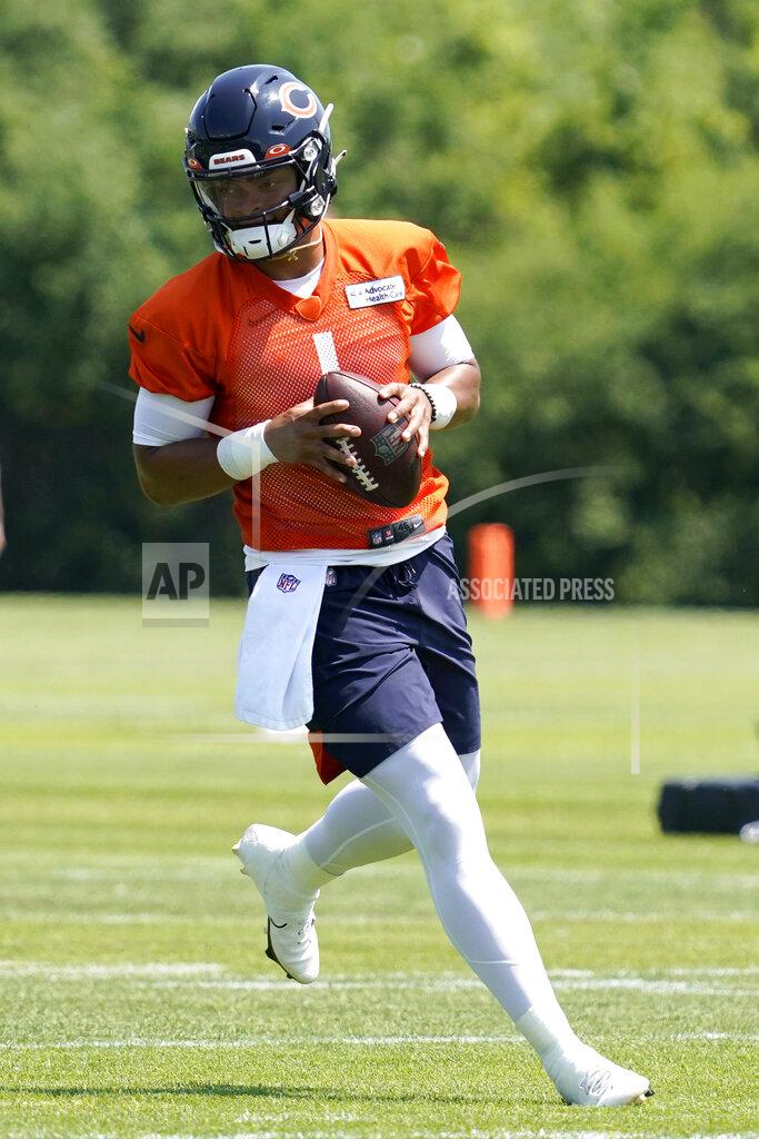 Nam Y. Huh Chicago Bears quarterback Justin Fields runs with a ball during NFL football practice in Lake Forest, Ill., Wednesday, June 9, 2021. (AP Photo/Nam Y. Huh)