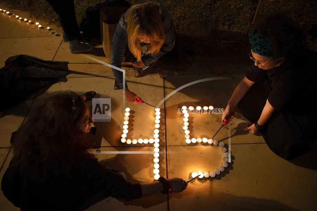 Oded Balilty People lit candles in memory of the 45 ultra-Orthodox Jews killed in a stampede at a religious festival on Friday, during a candle-light vigil in Tel Aviv, Israel, Saturday, May 1, 2021. The stampede early Friday had cut short the annual festival of Lag BaOmer on Israel's Mount Meron. The festival had drawn some 100,000 people in the largest gathering. (AP Photo/Oded Balilty)