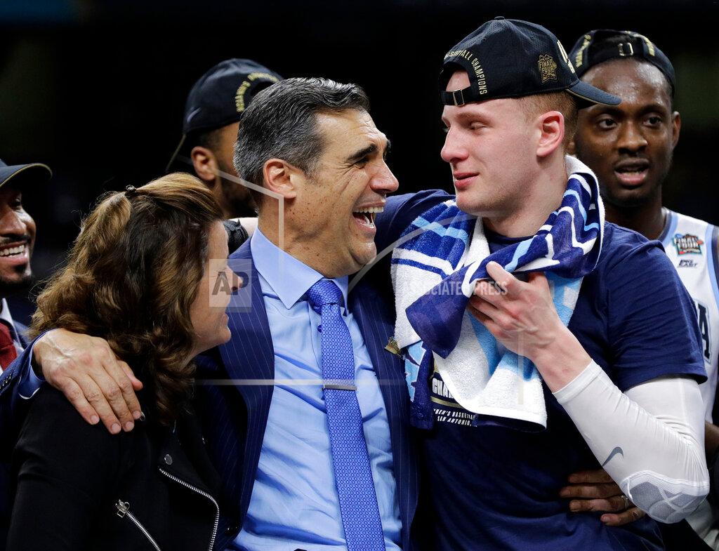 David J. Phillip FILE - In this April 2, 2018, file photo, Villanova head coach Jay Wright celebrates with guard Donte DiVincenzo, right, after beating Michigan 79-62 in the championship game of the Final Four NCAA college basketball tournament, in San Antonio. (AP Photo/David J. Phillip, File)