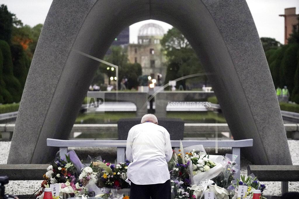 Eugene Hoshiko A man prays in front of the cenotaph for the atomic bombing victims before the start of ceremony to mark the 75th anniversary of the bombing in Hiroshima, western Japan, early Thursday, Aug. 6, 2020. (AP Photo/Eugene Hoshiko)