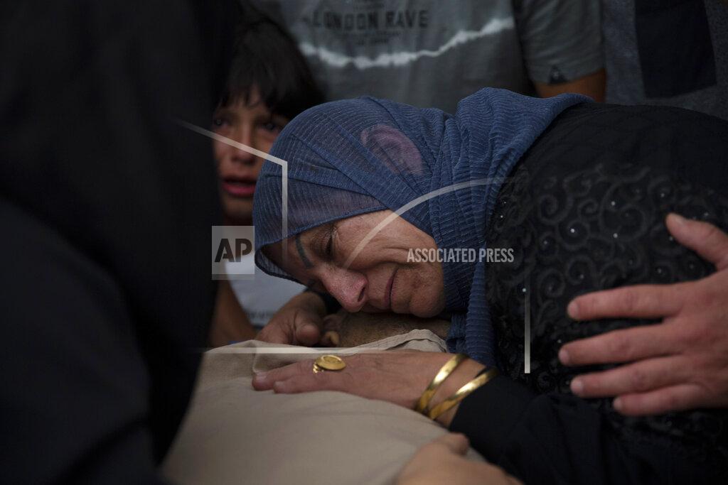 Majdi Mohammed A Palestinian woman mourns over the body of Raed Jadallah, 39, who was killed by Israeli forces at the western entrance of his village while returning from work in the early hours of Wednesday morning, during his funeral, in the West Bank village of Beit Ur al-Tahta, Wednesday, Sep. 1, 2021. (AP Photo/Majdi Mohammed)
