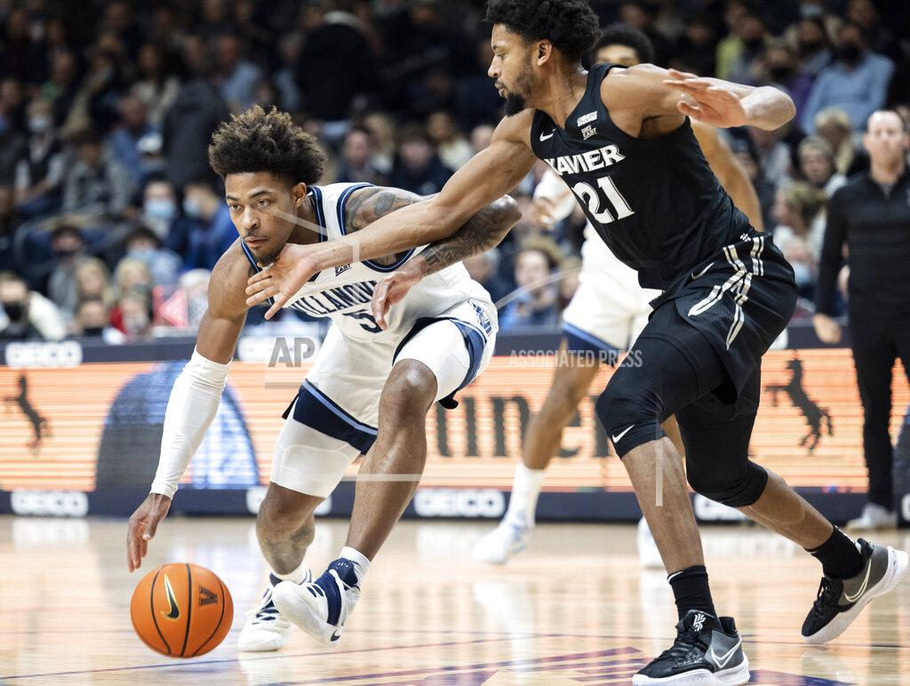 Laurence Kesterson Villanova guard Justin Moore (5) is fouled by Xavier forward Jerome Hunter (21) during the first half of an NCAA college basketball game Tuesday, Dec. 21, 2021, in Villanova, Pa. (AP Photo/Laurence Kesterson)