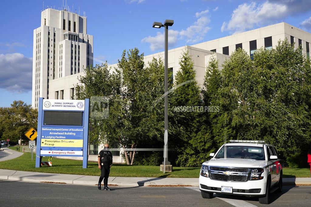Jacquelyn Martin A police officer blocks a road before President Donald Trump arrives at Walter Reed National Military Medical Center, in Bethesda, Md., Friday, Oct. 2, 2020, after he tested positive for COVID-19. (AP Photo/Jacquelyn Martin)