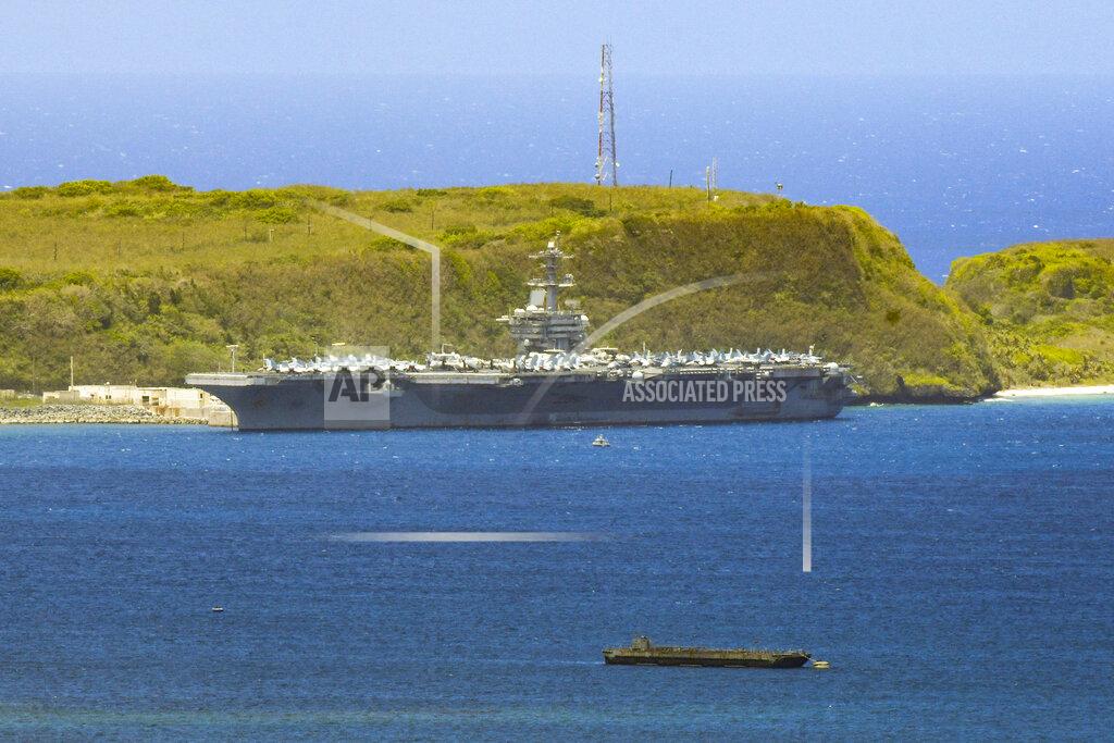 Rick Cruz FILE - In this April 3, 2020, file photo, the USS Theodore Roosevelt, a Nimitz-class nuclear powered aircraft carrier, is docked along Kilo Wharf of Naval Base Guam. The U.S. Navy says that after weeks of work, all of the roughly 4,800 sailors on the coronavirus-stricken USS Theodore Roosevelt aircraft carrier have been tested for the virus. The ship has been sidelined in Guam since March 27, moving sailors ashore, testing them and isolating them for nearly a month.(Rick Cruz/The Pacific Daily via AP, File)