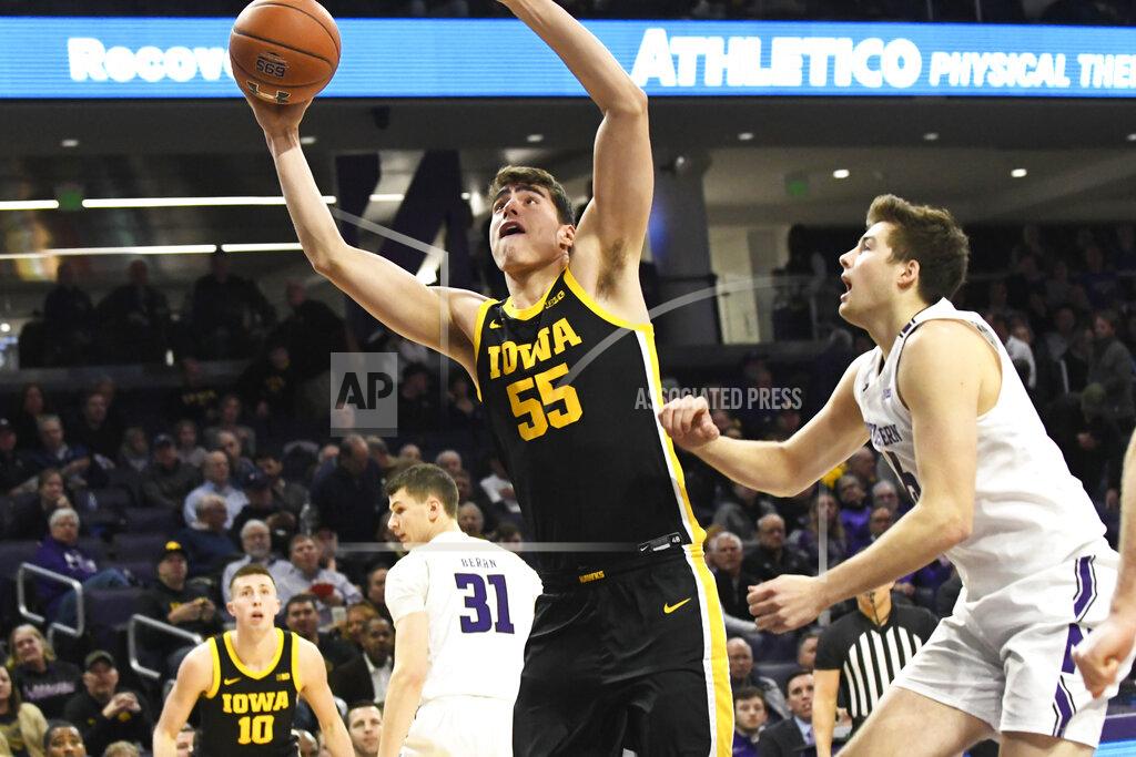 David Banks Iowa center Luka Garza (55) shoots as Northwestern center Ryan Young (15) defends during the first half of an NCAA college basketball game Tuesday, Jan. 14, 2020, in Evanston, Ill. (AP Photo/David Banks)