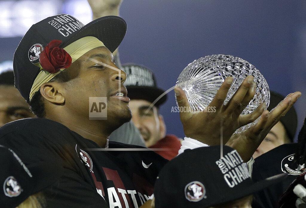 David J. Phillip FILE - In this Jan. 6, 2014, file photo, Florida State's Jameis Winston holds The Coaches' Trophy after the NCAA BCS National Championship college football game against Auburn, in Pasadena, Calif. Florida State won 34-31. (AP Photo/David J. Phillip, File)