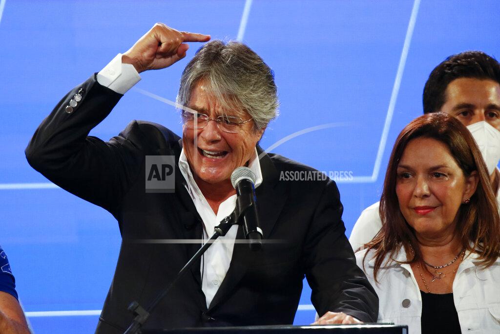 Angel Dejesus Guillermo Lasso, presidential candidate of the Creating Opportunities party or CREO, speaks in Guayaquil, Ecuador, after the closing of the general elections, Sunday, Feb. 7, 2021. Ecuadoreans went to the polls in a first round of presidential and legislative elections under strict sanitary measures due to the coronavirus pandemic. (AP Photo/Angel Dejesus)