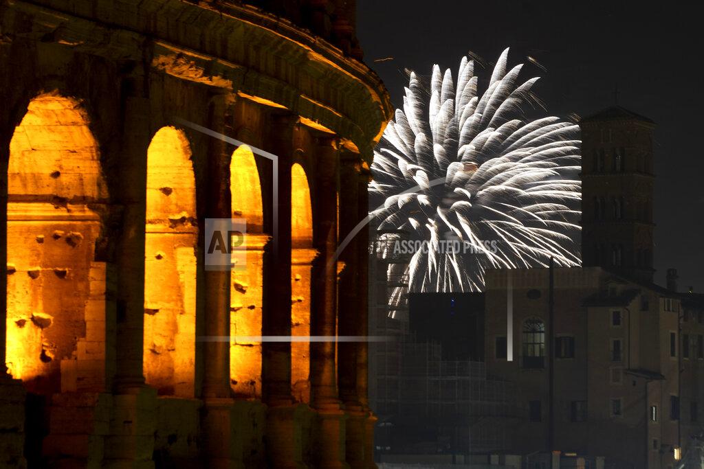 Andrew Medichini Fireworks explode in the sky next to Rome's Colosseum during New Year's celebrations, in Rome, Friday, Jan. 1, 2021. Italy went into a modified nationwide lockdown for the Christmas and New Year period, with restrictions on personal movement and commercial activity similar to the 10 weeks of hard lockdown Italy imposed from March to May when the country became the epicenter of the outbreak in Europe. (AP Photo/Andrew Medichini)