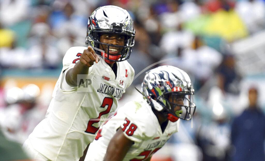 Jim Rassol Jackson State quarterback Shedeur Sanders (2) calls out play signals in the second quarter of an NCAA college football game against Florida A&M as running back Santee Marshall (38) looks on Sunday, Sept. 5, 2021, in Miami Gardens, Fla. (AP Photo/Jim Rassol)