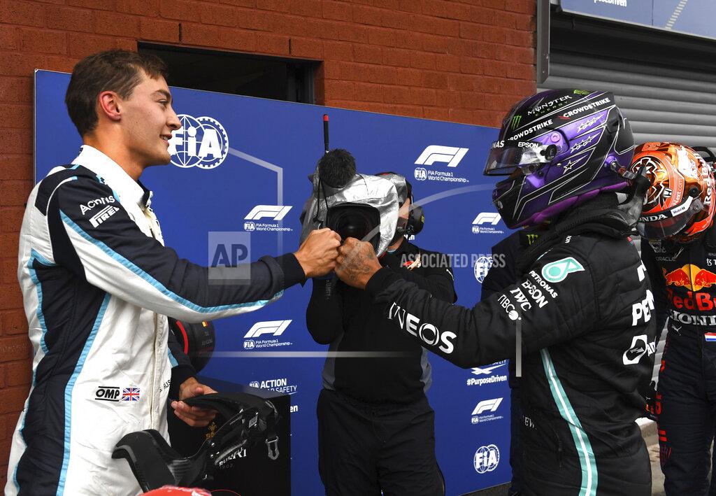 John Thys Second place Williams driver George Russell of Britain, left, fist bumps with third place Mercedes driver Lewis Hamilton of Britain after the qualification ahead of the Formula One Grand Prix at the Spa-Francorchamps racetrack in Spa, Belgium, Saturday, Aug. 28, 2021. The Belgian Formula One Grand Prix will take place on Sunday. (John Thys, Pool Photo via AP)