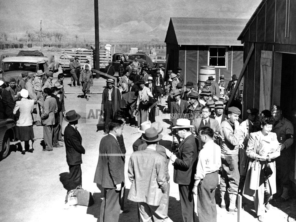 FILE - This March 23, 1942 photo shows the first arrivals at the Japanese evacuee community established in Owens Valley in Manzanar, Calif. Roughly 120,000 Japanese immigrants and Japanese-Americans were sent to camps that dotted the West because the government claimed they might plot against the U.S. The location is featured in a collection of mini-essays by American writers published online by the Frommer's guidebook company about places they believe helped shape and define America. (AP Photo/File)