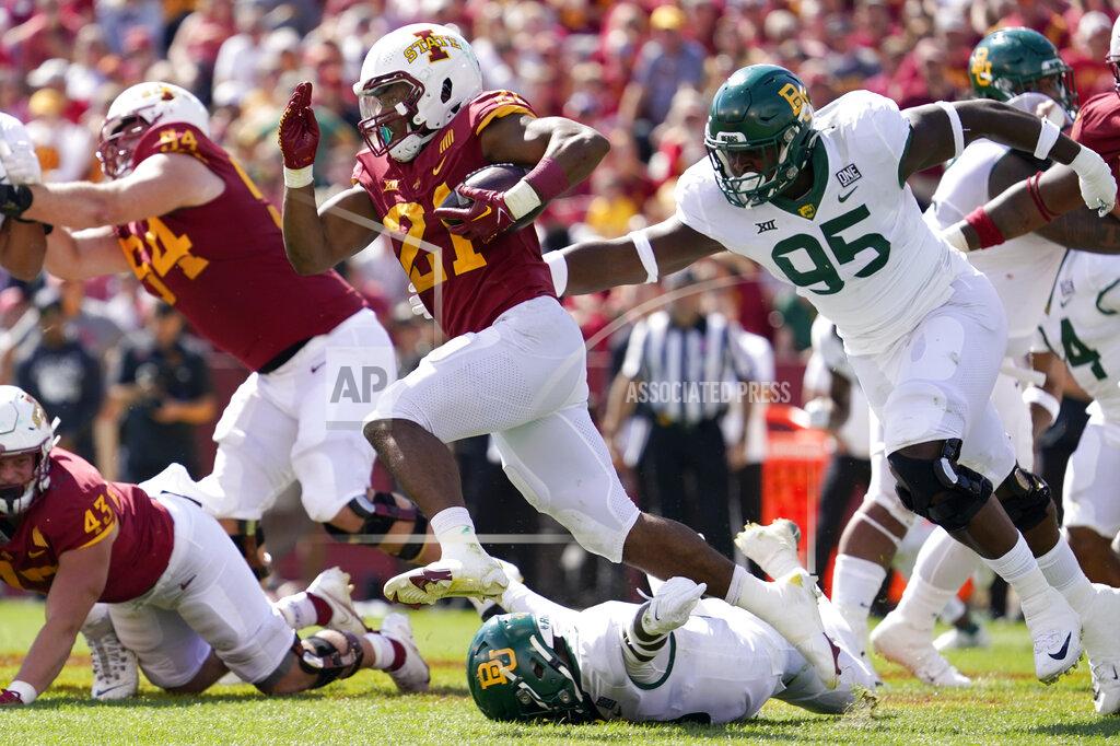 Charlie Neibergall Iowa State running back Jirehl Brock (21) runs from Baylor defensive lineman Gabe Hall (95) during the second half of an NCAA college football game, Saturday, Sept. 24, 2022, in Ames, Iowa. Baylor won 31-24. (AP Photo/Charlie Neibergall)