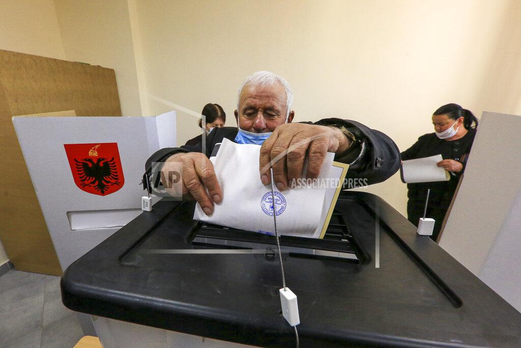 Hektor Pustina A man casts his ballot during parliamentary elections in Tirana, Sunday, April 25, 2021. Albanians are voting in parliamentary elections on Sunday amid the virus pandemic and a bitter rivalry between the two largest political parties. (AP Photo/Hektor Pustina)