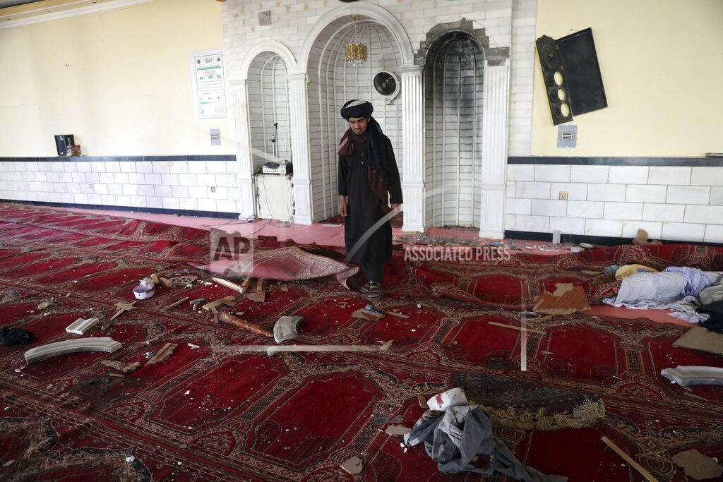 Rahmat Gul A religious student inspects inside a mosque after a bomb explosion in Shakar Dara district of Kabul, Afghanistan, Friday, May 14, 2021. A bomb ripped through a mosque in northern Kabul during Friday prayers killing 12 worshippers, Afghan police said. (AP Photo/Rahmat Gul)