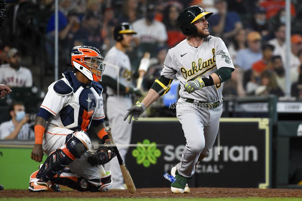 Eric Christian Smith Oakland Athletics' Jed Lowrie, right, watches his two-run single during the seventh inning of a baseball game against the Houston Astros, Saturday, April 10, 2021, in Houston. (AP Photo/Eric Christian Smith)