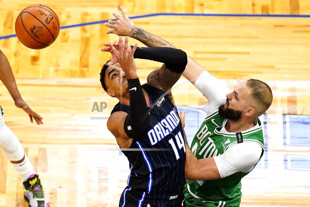 John Raoux Boston Celtics guard Evan Fournier, right, knocks the ball from the hands of Orlando Magic guard Gary Harris (14) during the first half of an NBA basketball game, Wednesday, May 5, 2021, in Orlando, Fla. (AP Photo/John Raoux)