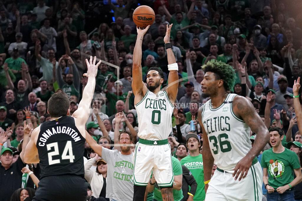 Steven Senne Boston Celtics forward Jayson Tatum (0) takes a shot at the basket as Milwaukee Bucks guard Pat Connaughton (24) defends while Celtics guard Marcus Smart (36) looks on during the second half of Game 7 of an NBA basketball Eastern Conference semifinals playoff series, Sunday, May 15, 2022, in Boston. The Celtics won 109-81. (AP Photo/Steven Senne)