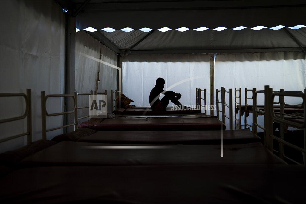 Emilio Morenatti Mamadou Patherazi, from Guinea, sits on a bunk bed of the Modern Christian Mission Church in Fuerteventura, one of the Canary Islands, Spain, on Saturday, Aug. 22, 2020. The Modern Christian Mission is the main shelter for rescued migrants on the island of Fuerteventura. Some 4,000 migrants have reached the Canaries so far this year, the most in over a decade, raising alarm at the highest levels of the Spanish government. (AP Photo/Emilio Morenatti)