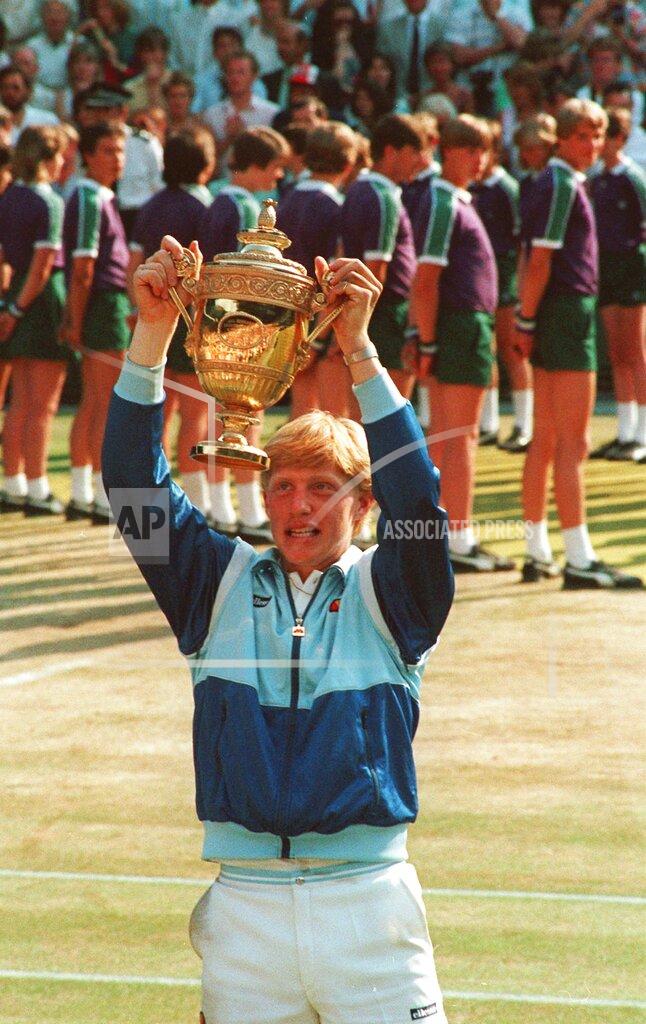 Bob Dear FILE - In this July 7, 1985, file photo, 17-year-old Boris Becker holds the Wimbledon trophy aloft after defeating South Africa's Kevin Curren. (AP Photo/Bob Dear, File)
