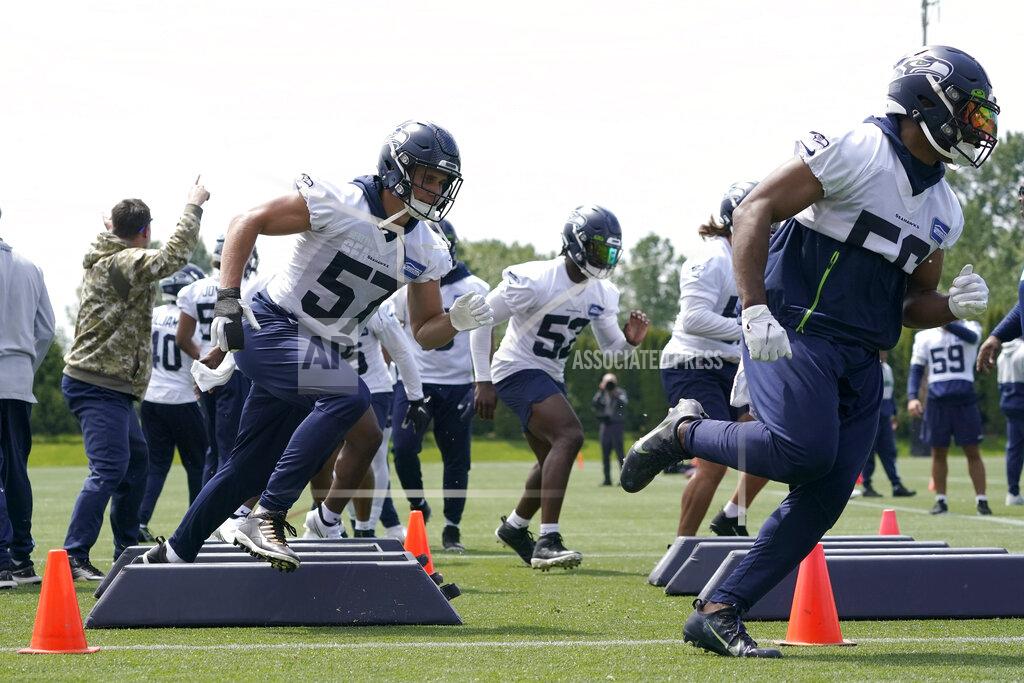 Ted S. Warren Seattle Seahawks linebackers Cody Barton (57) and Jordan Brooks, right, run a drill during NFL football practice Monday, May 23, 2022, in Renton, Wash. (AP Photo/Ted S. Warren)