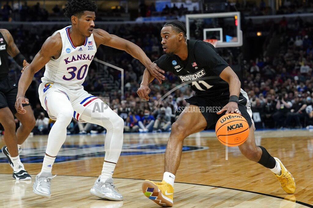 Nam Y. Huh Providence's A.J. Reeves tries to get past Kansas' Ochai Agbaji during the first half of a college basketball game in the Sweet 16 round of the NCAA tournament Friday, March 25, 2022, in Chicago. (AP Photo/Nam Y. Huh)