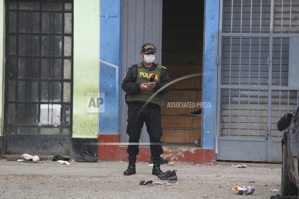 Martin Mejia A police officer guards the entrance to the Tomas Restobar disco where officials say 13 people died in a stampede after a police raid to enforce the country's lockdown during the coronavirus pandemic, Sunday, Aug. 23, 2020. The stampede happened when about 120 people that had gathered for a party on Saturday night, tried to escape through the only door of the second-floor disco, trampling one another and becoming trapped in the confined space, according to authorities. (AP Photo/Martin Mejia)