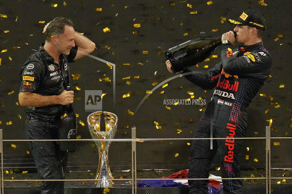 Hassan Ammar Red Bull team chief Christian Horner, left, celebrates with his driver Max Verstappen of the Netherlands after winning the Formula One Abu Dhabi Grand Prix in Abu Dhabi, United Arab Emirates, Sunday, Dec. 12, 2021. Max Verstappen ripped a record eighth title away from Lewis Hamilton with a pass on the final lap of the Abu Dhabi GP to close one of the most thrilling Formula One seasons in years as the first Dutch world champion. (AP Photo/Hassan Ammar)