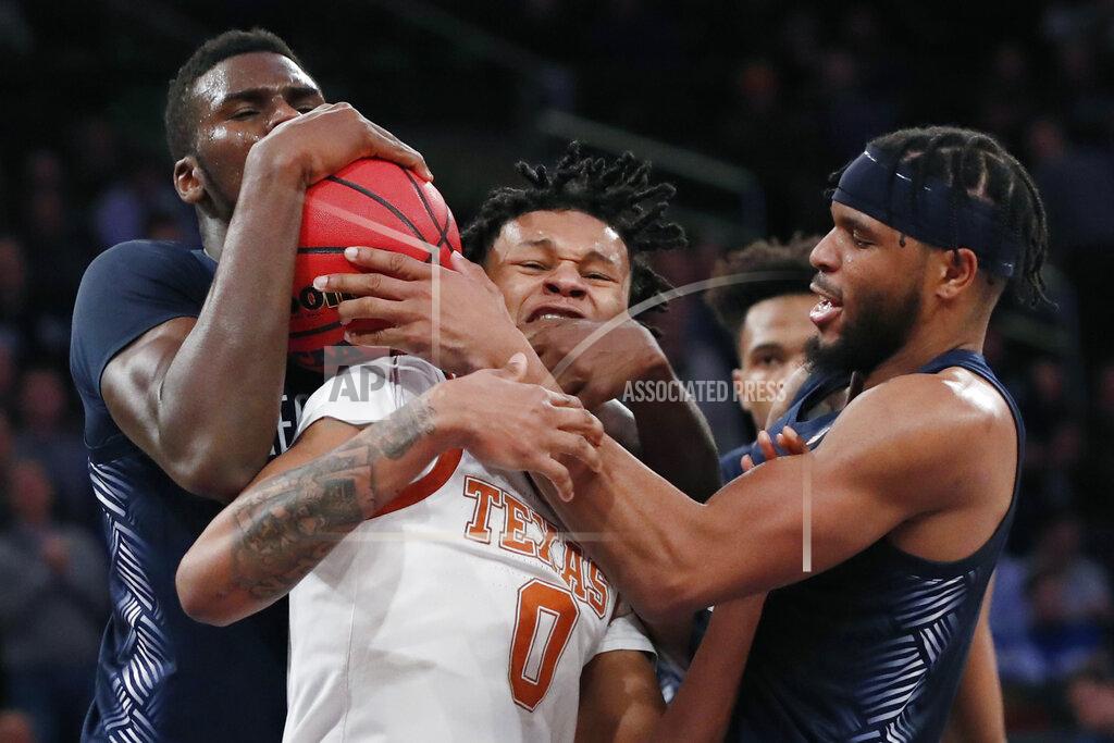 Kathy Willens Georgetown center Qudus Wahab, left, and and guard Jagan Mosely, right, struggle to control the ball at the expense of Texas forward Gerald Liddell (0) during the second half of the first round of the 2K Empire Classic NCAA college basketball tournament, Thursday, Nov. 21, 2019, in New York. Georgetown defeated Texas 82-66. (AP Photo/Kathy Willens)