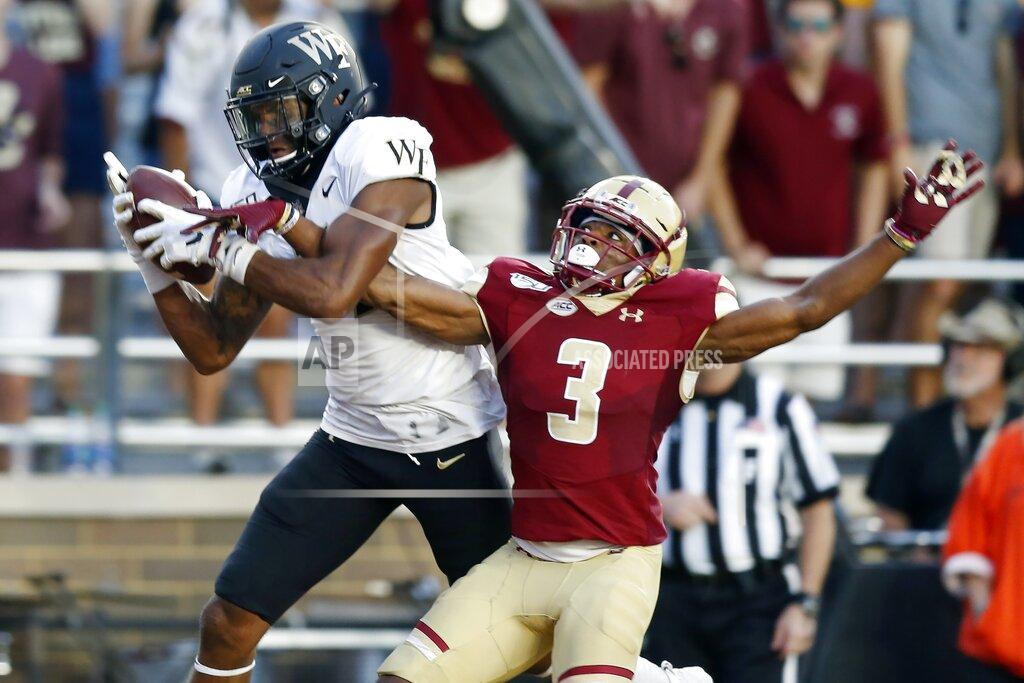 Michael Dwyer Wake Forest wide receiver Scotty Washington, left, makes a touchdown reception against Boston College defensive back Jason Maitre (3) during the second half of an NCAA college football game in Boston, Saturday, Sept. 28, 2019. (AP Photo/Michael Dwyer)