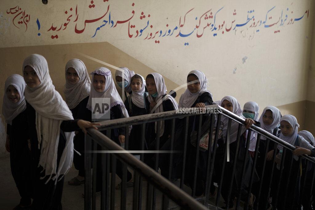 Felipe Dana Girls walk upstairs as they enter a school before class in Kabul, Afghanistan, Sunday, Sept. 12, 2021. (AP Photo/Felipe Dana)