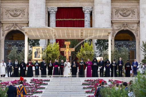FILE - Pope Francis standing with church leaders in front of a replica of the icon 'Maria Salus populi romani'' and the St. Damian crucifix, blesses the participants into &quot;Together&quot;, a vigil prayer for the Synod of Bishops in St. Peter's Square at The Vatican, Saturday, Sept. 30, 2023, three days ahead of the official opening of the XVI Assembly of the Synod of Bishops on 4 October. Pope Francis is convening a global gathering of bishops and laypeople to discuss the future of the Catholic Church, including some hot-button issues that have previously been considered off the table for discussion. Key agenda items include women's role in the church, welcoming LGBTQ+ Catholics and how bishops exercise authority. For the first time, women and laypeople can vote on specific proposals alongside bishops. (AP Photo/Riccardo De Luca, File)
