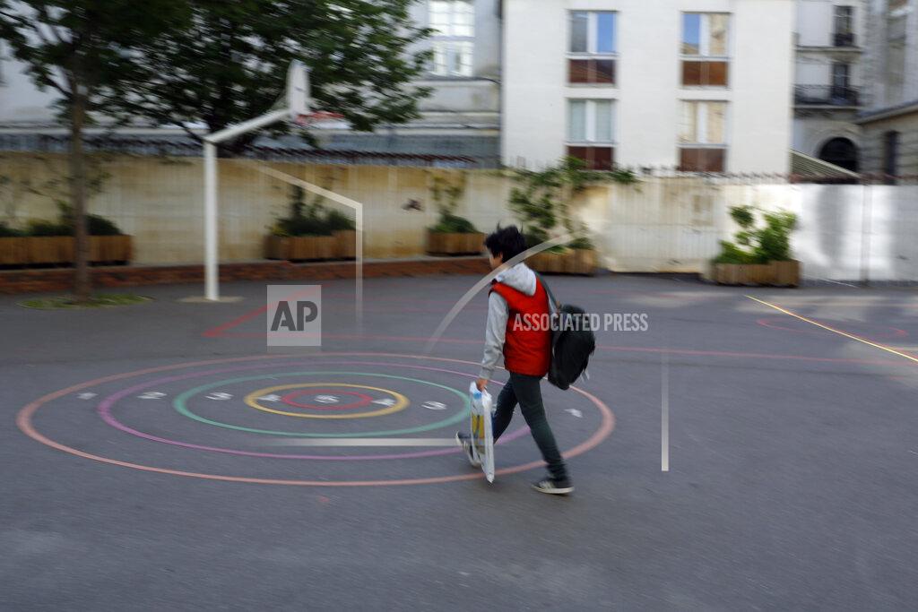 Thibault Camus A children walks in the courtyard of the Vaucanson school, in Paris, Thursday, May 14, 2020. The government has allowed parents to keep children at home amid fears prompted by the COVID-19, as France is one of the hardest-hit countries in the world. Authorities say 86% of preschools and primary schools are reopening this week. (AP Photo/Thibault Camus)