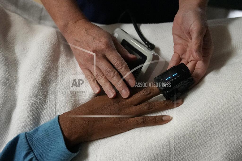 Rebecca Blackwell A nurse checks the vitals of a 33-year-old mother of three from central Texas as she rests after getting an abortion, Saturday, Oct. 9, 2021, at Hope Medical Group for Women in Shreveport, La. She said having another child at this point in her life would take away from her ability to care for her other three children, so she drove alone four hours through the night to make it to the clinic for her initial consultation. (AP Photo/Rebecca Blackwell)
