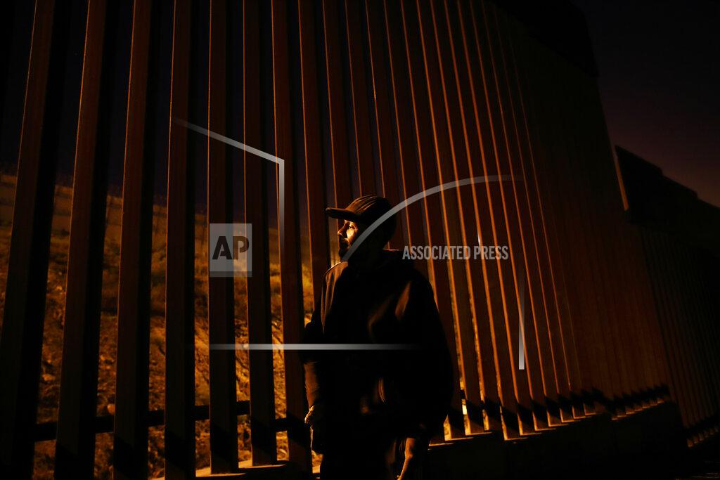 Gregory Bull FILE- Armando Mayorga, originally from Nicaragua, but deported from the United States after living in California for years, looks towards the United States through the newly replaced border structure Wednesday, Jan. 9, 2019, in Tijuana, Mexico. Top Trump administration officials will visit South Texas five days before Election Day to announce they have completed 400 miles of U.S.-Mexico border wall, attempting to show progress on perhaps the president's best-known campaign promise four years ago. But most of the wall went up in areas that already had smaller barriers. (AP Photo/Gregory Bull)