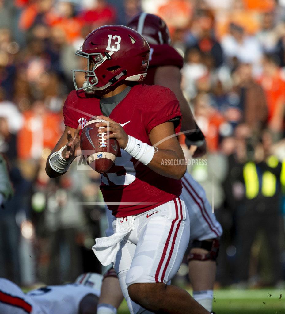 Vasha Hunt Alabama quarterback Tua Tagovailoa (13) rolls out against Auburn during the first half of an NCAA college football game, Saturday, Nov. 24, 2018, in Tuscaloosa, Ala. (AP Photo/Vasha Hunt)
