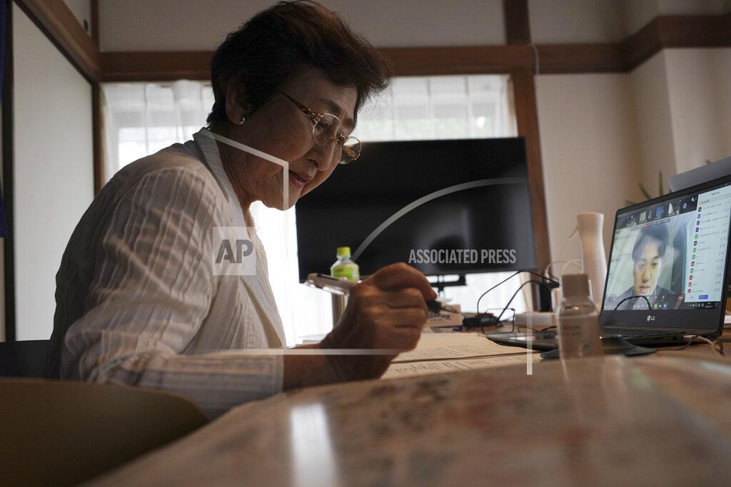 Eugene Hoshiko Michiko Kodama, assistant secretary-general of the Japan Confederation of A and H Bomb Sufferers' Organizations, takes a question from an audience after she narrated her experience on a livestream of "Kataribe" or story-telling session Sunday, July 12, 2020, in Tokyo. “For me, the war is not over yet,” said Michiko Kodama, 82, who survived the bombing but has lost most of her relatives from cancer, including one of her two daughters. Years after the atomic bombing, a receptionist at a clinic near Tokyo noted Kodama's “hibakusha” medical certificate in a loud voice, and a patient sitting next to her in a waiting room moved away from her. The fear of death, prejudice and discrimination at work and in marriage continues, and nuclear weapons still exist. (AP Photo/Eugene Hoshiko)