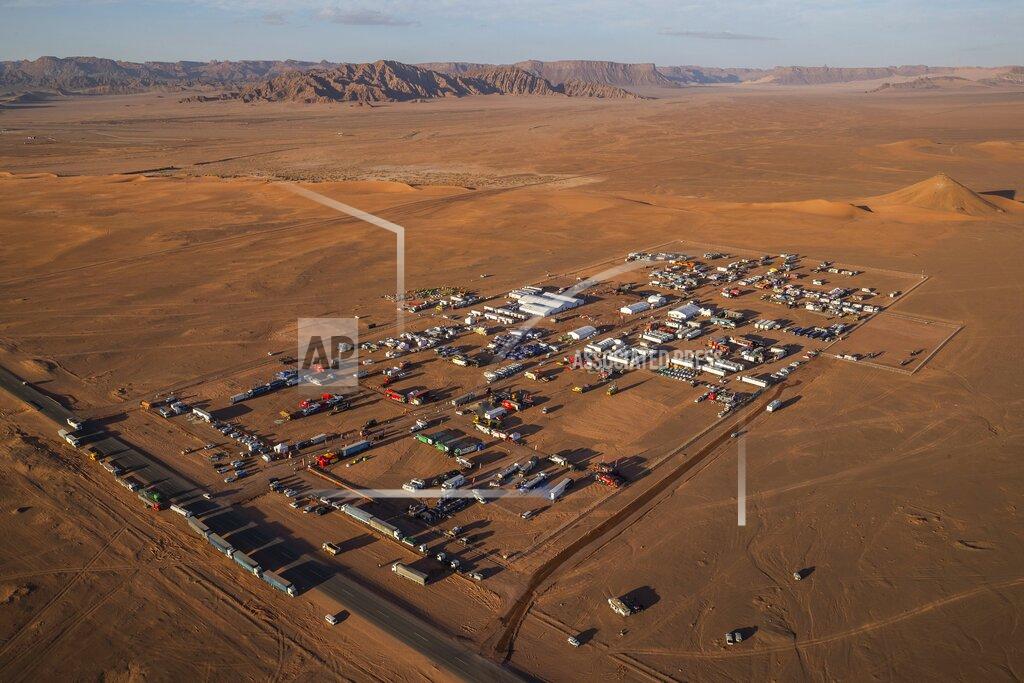 Bernat Armangue In this Wednesday, Jan. 8, 2020 photo, an overview of the Dakar rally bivouac in Al Ula, in Saudi Arabia. Formerly known as the Paris-Dakar Rally, the race was created by Thierry Sabine after he got lost in the Libyan desert in 1977. Until 2008, the rallies raced across Africa, but threats in Mauritania led organizers to cancel that year's event and move it to South America. It has now shifted to Saudi Arabia. The race started on Jan. 5 with 560 drivers and co-drivers, some on motorbikes, others in cars or in trucks. Only 41 are taking part in the Original category. (AP Photo/Bernat Armangue)