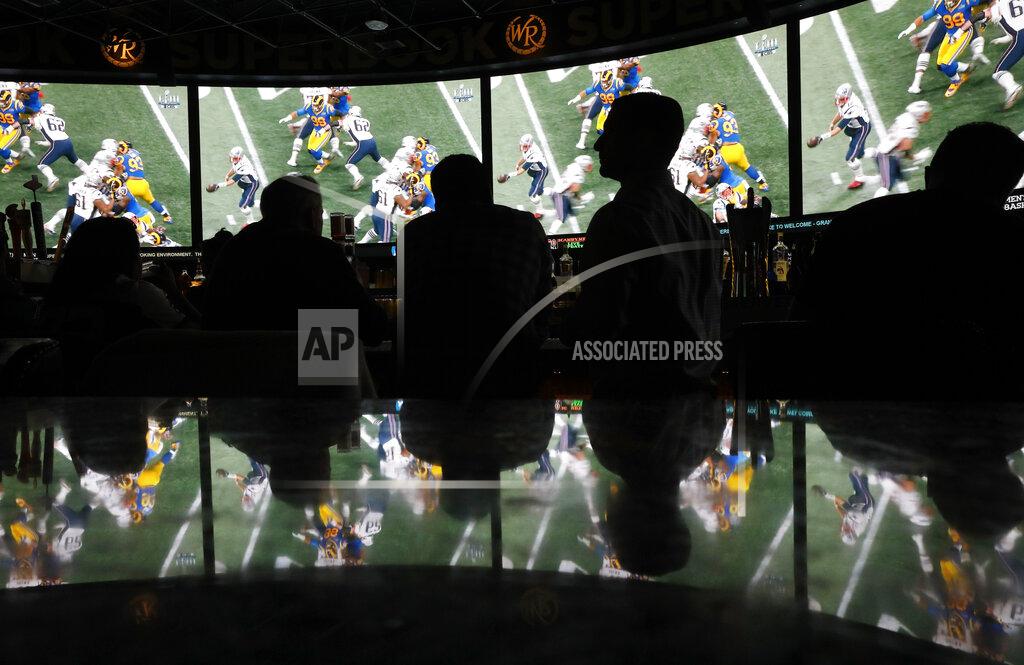 People watch Super Bowl LIII at the Westgate Superbook sports book, Sunday, Feb. 3, 2019, in Las Vegas. (AP Photo/John Locher)