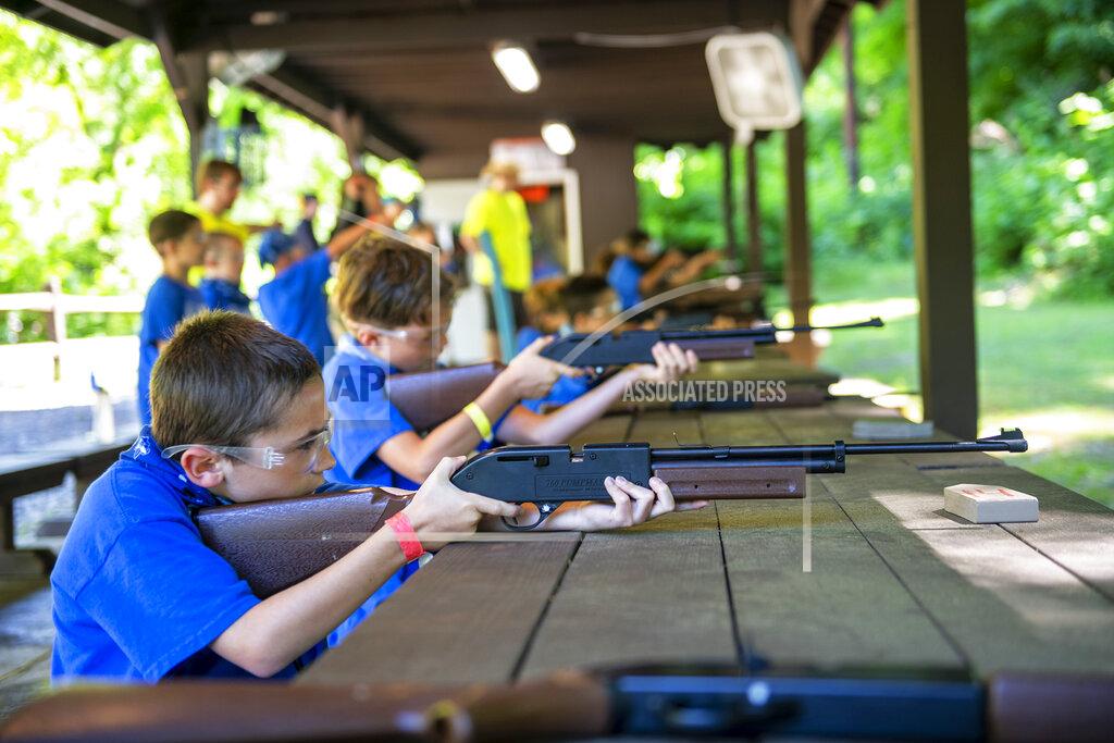 Michael M. Santiago Sylas Sekely, 8, of Monroeville, Pa., concentrates as he prepares to shoot at a target with a BB gun Thursday, June 11, 2020, at Camp Guyasuta in Sharpsburg, Pa. Camp Guyasuta's STEM Adventure Day Camp started for the summer on Monday, one of a handful of camps to open with adjusted protocols due to the COVID-19 pandemic. (Michael M. Santiago/Pittsburgh Post-Gazette via AP)