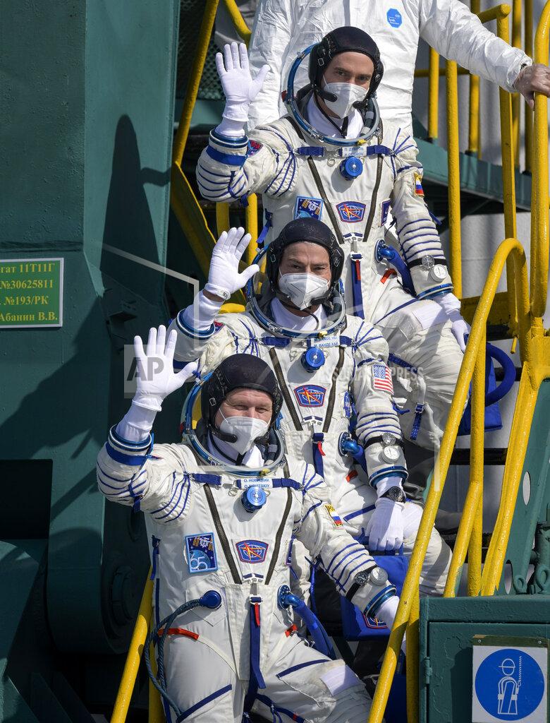 Bill Ingalls In this image provided by NASA, Russian cosmonaut Pyotr Dubrov, top, NASA astronaut Mark Vande Hei, middle, and Russian cosmonaut Oleg Novitskiy wave farewell prior to boarding the Soyuz MS-18 spacecraft for launch, Friday, April 9, 2021, at the Baikonur Cosmodrome in Kazakhstan. The astronaut and cosmonauts are scheduled to launch aboard the Soyuz MS-18 spacecraft Friday, to rendezvous with the International Space Station.(Bill Ingalls/NASA via AP)