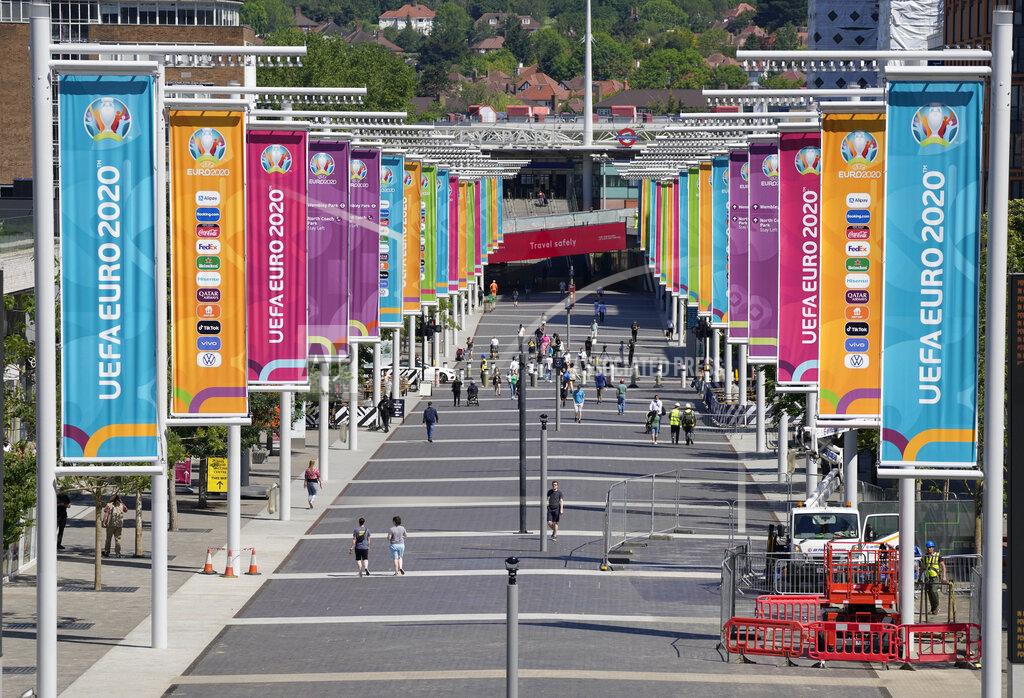 Frank Augstein FILE - In this Wednesday, June 9, 2021 file photo,a view of the entrance path to Wembley stadium, ahead of the upcoming Euro 2020 soccer championship in London. The British government says more than 60,000 fans will be allowed into the semifinals and final of the European Championship at Wembley Stadium. No details have been provided yet on how fans from overseas can attend without having to quarantine after flying into London. (AP Photo/Frank Augstein, File)