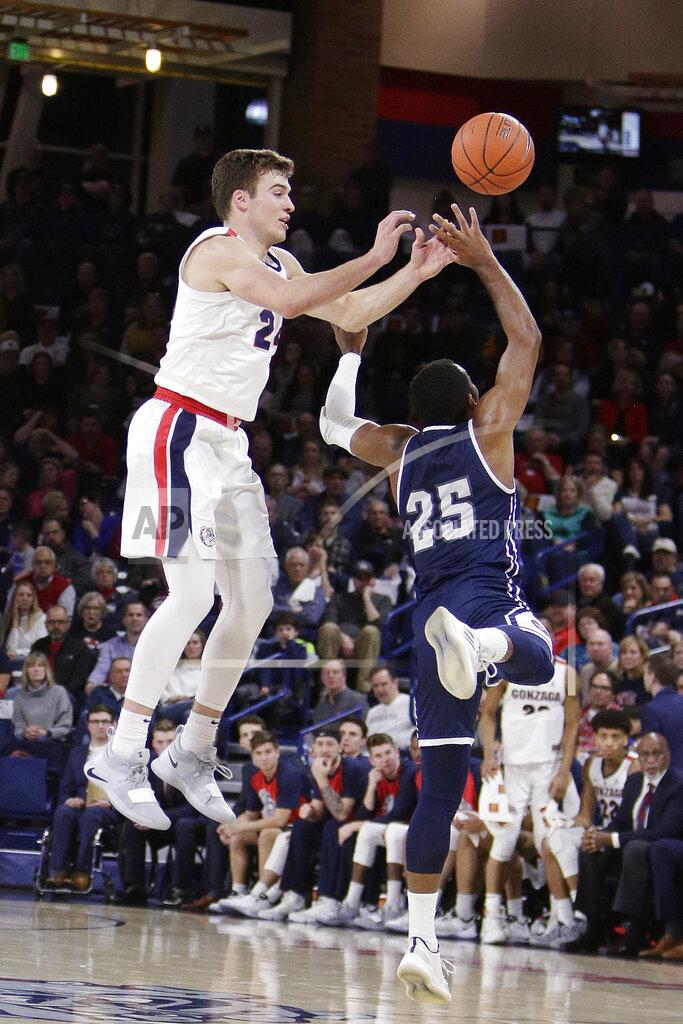 Young Kwak Gonzaga forward Corey Kispert, left, and Loyola Marymount guard Jeffery McClendon (25) go after the ball during the first half of an NCAA college basketball game in Spokane, Wash., Thursday, Jan. 17, 2019. (AP Photo/Young Kwak)
