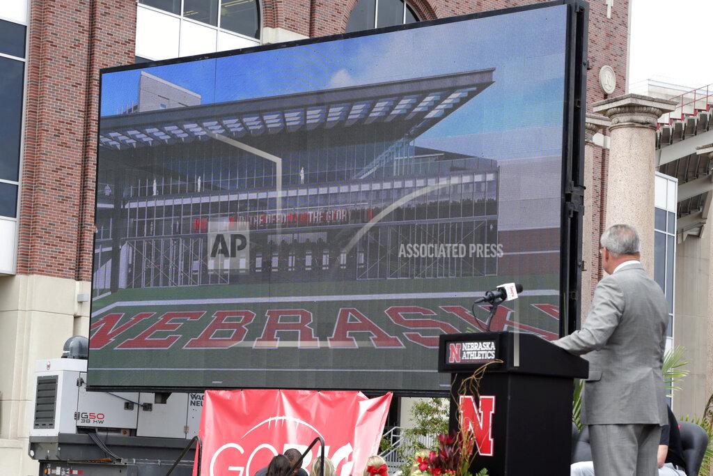 Nati Harnik Nebraska Athletic Director Bill Moos, right, presents an artists rendering of a new planned $150 million football training facility adjacent to Memorial Stadium, during an NCAA college football news conference, Friday, Sept. 27, 2019, in Lincoln, Neb.. (AP Photo/Nati Harnik)