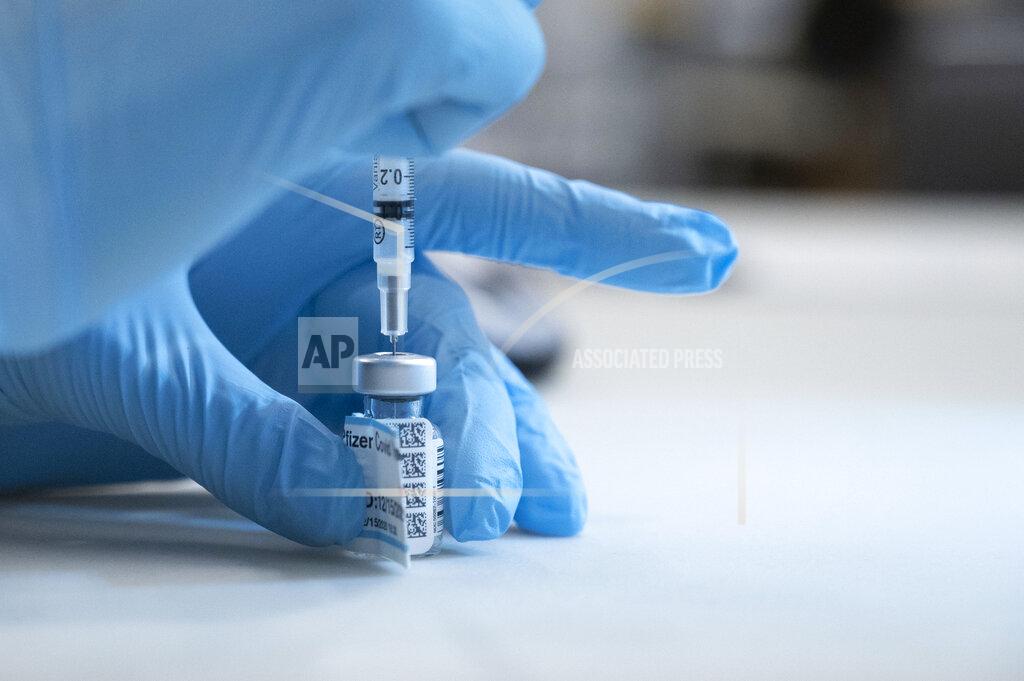 UC Davis Medical Center nurse Heather Donaldson prepares to inoculate a staff member with the Pfizer-BioNTech COVID-19 vaccine, Tuesday, Dec. 15, 2020 in Sacramento, Calif. (AP Photo/Hector Amezcua, Pool)