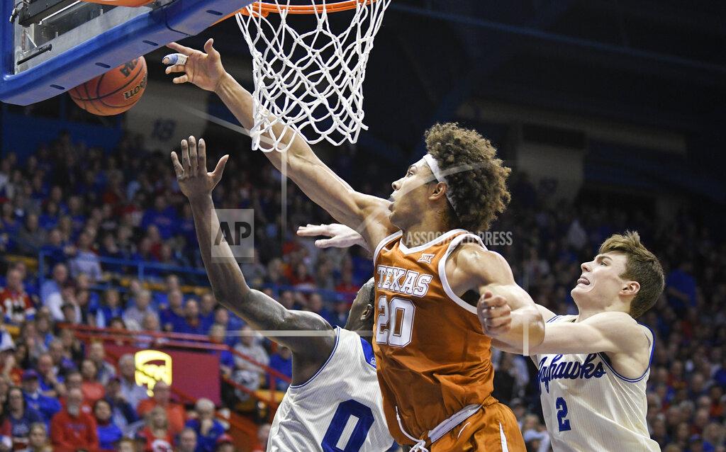 Reed Hoffmann Texas forward Jericho Sims (20) fights for a rebound again Kansas Jayhawks Marcus Garrett (0) and Kansas guard Christian Braun (2) during the second half of an NCAA college basketball game in Lawrence, Kan., Monday, Feb. 3, 2020. (AP Photo/Reed Hoffmann