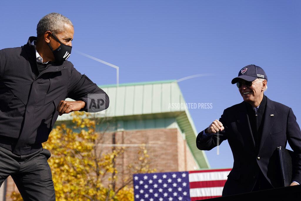 Andrew Harnik FILE - In this Oct. 31, 2020, file photo Democratic presidential candidate former Vice President Joe Biden, right, and former President Barack Obama greet each other with an air elbow bump, at the conclusion of rally at Northwestern High School in Flint, Mich. (AP Photo/Andrew Harnik, File)