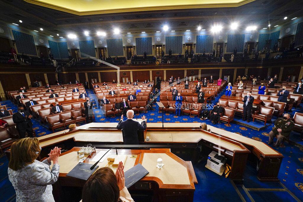 Melina Mara President Joe Biden addresses a joint session of Congress, Wednesday, April 28, 2021, in the House Chamber at the U.S. Capitol in Washington, as Vice President Kamala Harris and House Speaker Nancy Pelosi of Calif., stand and applaud. (Melina Mara/The Washington Post via AP, Pool)