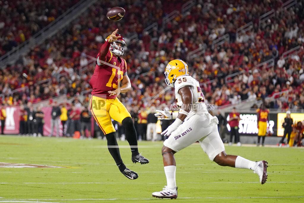 Mark J. Terrill Southern California quarterback Caleb Williams, left, throws a touchdown pass as Arizona State defensive lineman B.J. Green II defends during the first half of an NCAA college football game Saturday, Oct. 1, 2022, in Los Angeles. (AP Photo/Mark J. Terrill)